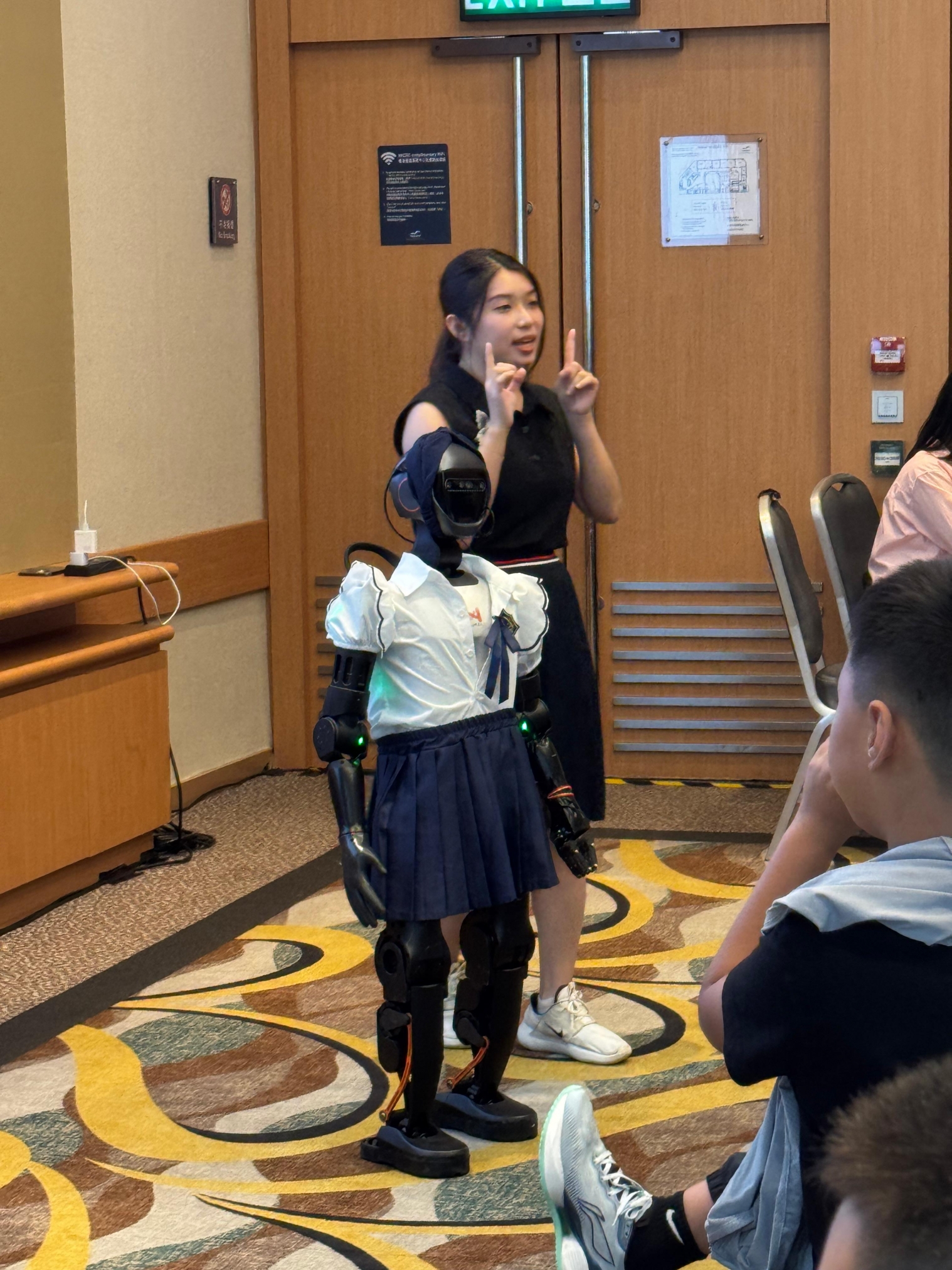 A person and person standing in front of a large screenAI-generated content may be incorrect.