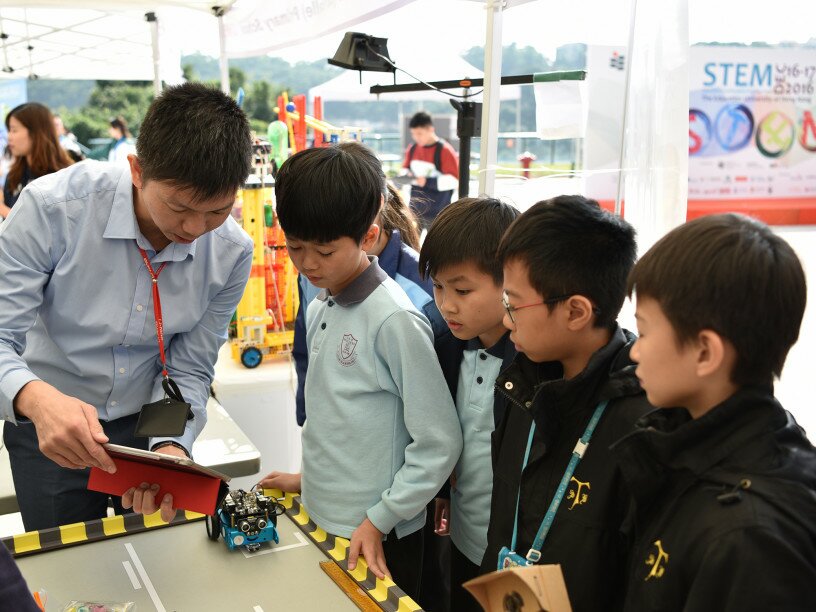 A number of exhibition or game booths are set up to demonstrate successful STEM trials or experiments.