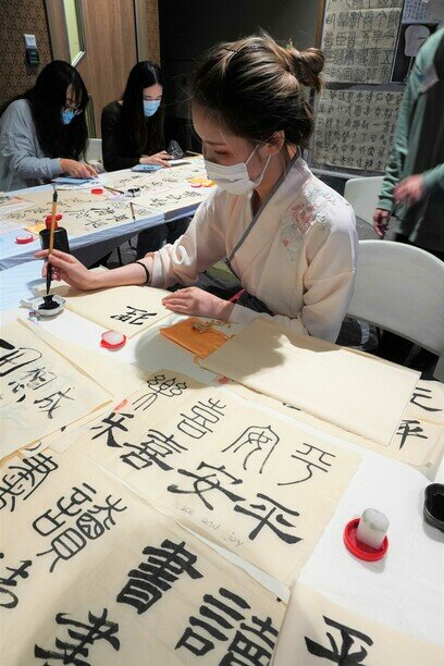 An exchange student from mainland China demonstrates Chinese calligraphy