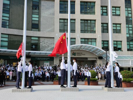 A flag raising team made up of EdUHK students take up the national flag raising duty during the ceremony