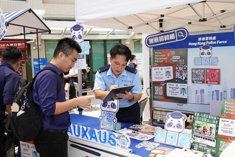 Students engaging with government representatives at the interactive booth, exploring job opportunities at public service sector 