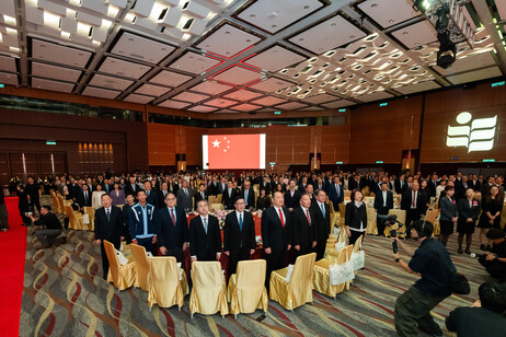 More than 600 guests stand to pay respect during the playing of the national anthem