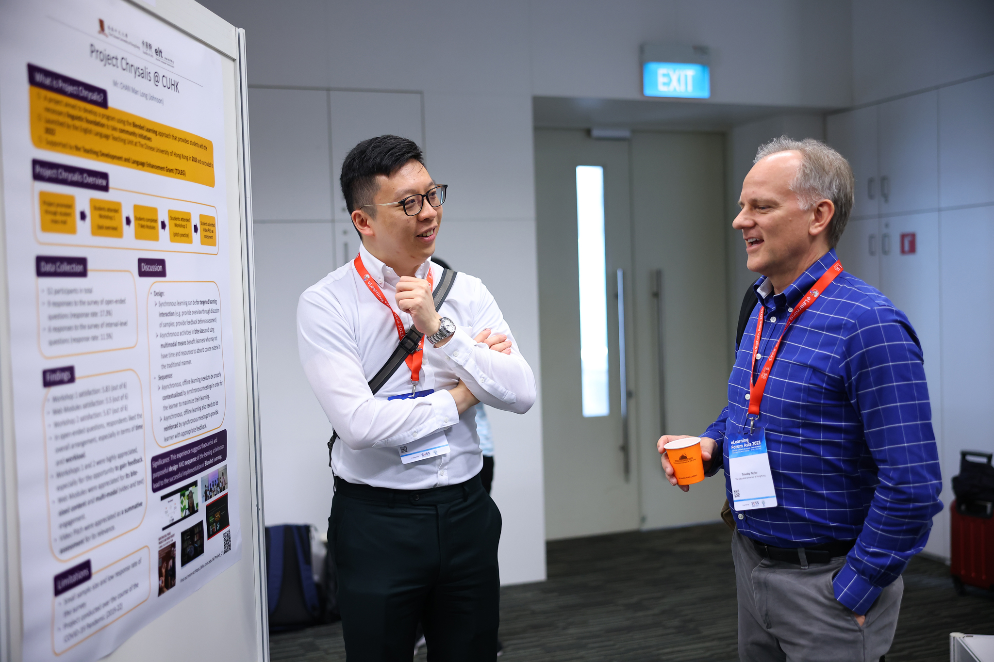 Dr Taylor is discussing the poster presentation delivered by Mr Chan from The Chinese University of Hong Kong